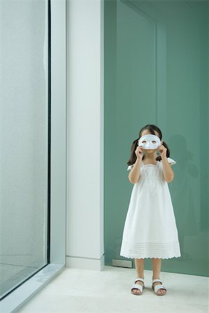 simsearch:632-01193783,k - Little girl holding mask in front of eyes Stock Photo - Premium Royalty-Free, Code: 696-03402135