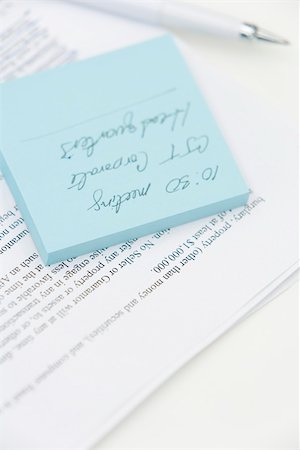 self adhesive note - Message written on adhesive note and document, close-up Stock Photo - Premium Royalty-Free, Code: 696-03402575