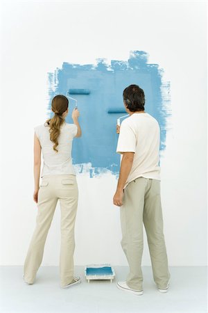 simsearch:696-03395895,k - Couple painting wall blue using rollers, rear view Stock Photo - Premium Royalty-Free, Code: 696-03402685