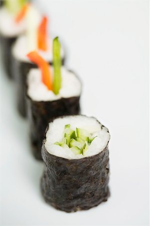 simsearch:6118-07354031,k - Row of maki sushi, close-up, focus on foreground Stock Photo - Premium Royalty-Free, Code: 696-03402772