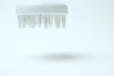 Hair dryer diffuser hovering in midair, close-up Stock Photo - Premium Royalty-Free, Code: 696-03402913