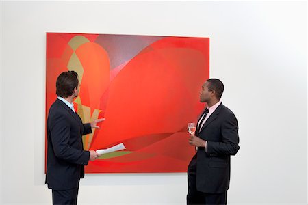 fine art - Two males talking over painting in art gallery Stock Photo - Premium Royalty-Free, Code: 693-05552756