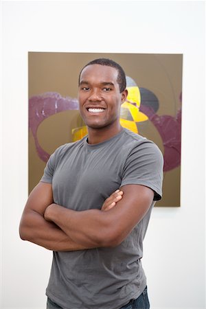 simsearch:693-05552760,k - Portrait of young man with arms crossed in front of wall painting Stock Photo - Premium Royalty-Free, Code: 693-05552777