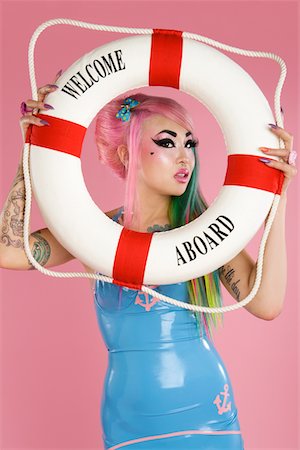 simsearch:693-05552824,k - Young woman holding float tube over pink background Stock Photo - Premium Royalty-Free, Code: 693-05552836