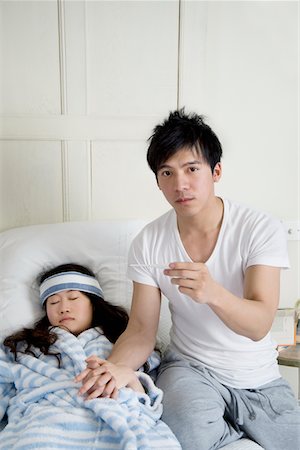 Portrait de jeune homme tandis que femme au lit Photographie de stock - Premium Libres de Droits, Code: 693-05553246