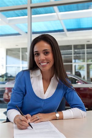 Portrait of young female signing document Stock Photo - Premium Royalty-Free, Code: 693-05794015