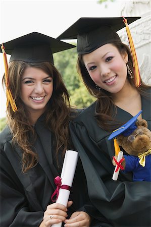 simsearch:693-06014177,k - Two graduates holding diploma and teddy bear, portrait Stock Photo - Premium Royalty-Free, Code: 693-06014148