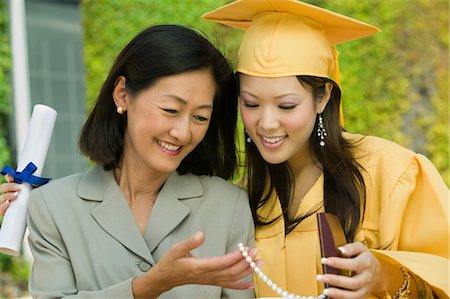 simsearch:693-06014177,k - Graduate and mother admiring necklace gift outside Stock Photo - Premium Royalty-Free, Code: 693-06014165