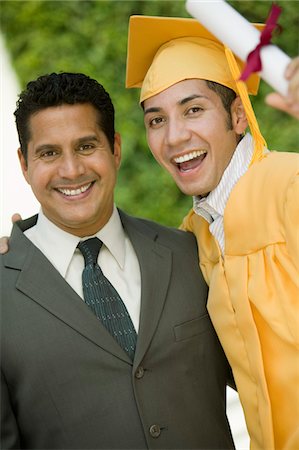 simsearch:693-06014177,k - Graduate hoisting diploma with arm around father outside, portrait Stock Photo - Premium Royalty-Free, Code: 693-06014163