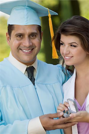 simsearch:693-06014177,k - Middle-aged graduate receiving present from daughter outdoors Stock Photo - Premium Royalty-Free, Code: 693-06014177