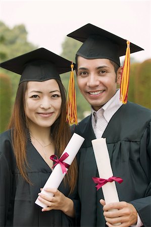 simsearch:693-06014177,k - Two graduates holding diplomas outside, portrait Stock Photo - Premium Royalty-Free, Code: 693-06014179
