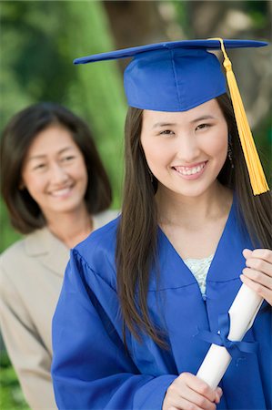 simsearch:693-06014177,k - Graduate holding diploma with mother behind, outside, portrait Stock Photo - Premium Royalty-Free, Code: 693-06014171