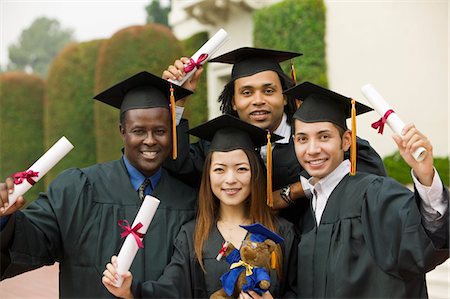 simsearch:693-06014177,k - Graduates hoisting diplomas outside, portrait Stock Photo - Premium Royalty-Free, Code: 693-06014180