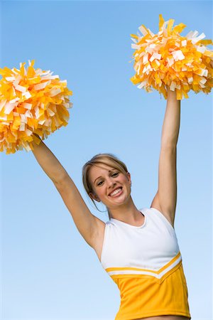 simsearch:693-03299836,k - Smiling Cheerleader rising pom-poms, (portrait), (low angle view) Stock Photo - Premium Royalty-Free, Code: 693-06014245