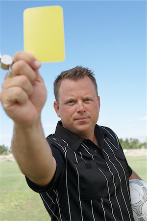 referee (male) - Soccer Referee Showing Yellow Card Stock Photo - Premium Royalty-Free, Code: 693-06014269