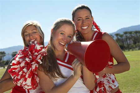 Cheerleaders Holding Megaphone on field, portrait, (portrait) Stock Photo - Premium Royalty-Free, Code: 693-06014429