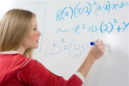 student whiteboard - Female student writing maths equations on whiteboard Stock Photo - Premium Royalty-Free, Code: 693-06014838