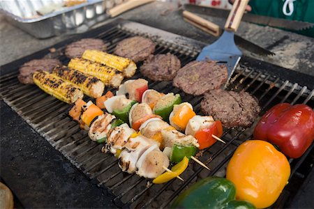 Burgers and Kebabs on Barbecue Grill Stock Photo - Premium Royalty-Free, Code: 693-06015279