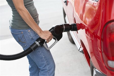 simsearch:6105-05395912,k - Young woman filling up car with gas, mid section Stock Photo - Premium Royalty-Free, Code: 693-06015510