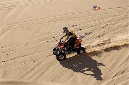 Young Man Riding ATV Over Sand Dune Stock Photo - Premium Royalty-Free, Code: 693-06015645