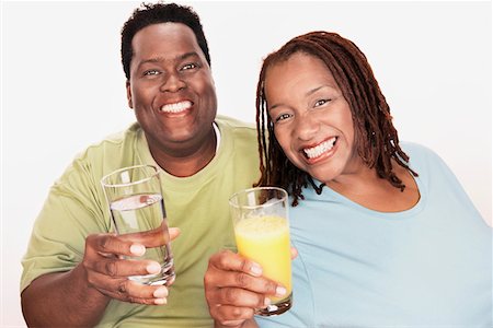 fat black woman - Overweight Couple holding healthy beverage, smiling, portrait Stock Photo - Premium Royalty-Free, Code: 693-06016259