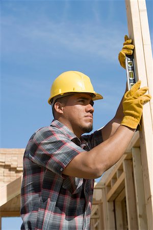simsearch:693-06016727,k - Construction worker using spirit level on building Stock Photo - Premium Royalty-Free, Code: 693-06016707