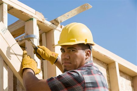 simsearch:693-06016727,k - Construction worker using hammer on building Stock Photo - Premium Royalty-Free, Code: 693-06016709
