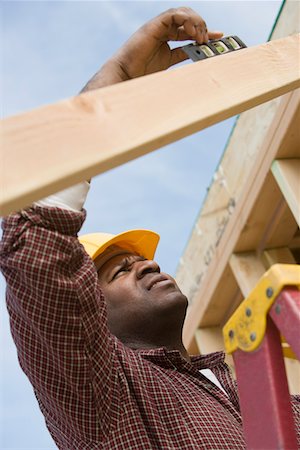 simsearch:693-06016727,k - Construction worker using spirit level on building Stock Photo - Premium Royalty-Free, Code: 693-06016719