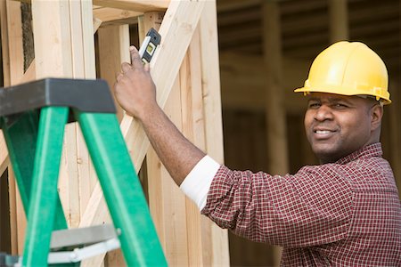 simsearch:693-06016727,k - Construction worker using spirit level on building Stock Photo - Premium Royalty-Free, Code: 693-06016725