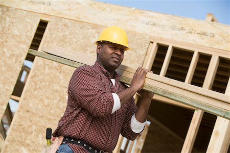 simsearch:693-06016727,k - Construction worker carrying wooden plank Stock Photo - Premium Royalty-Free, Code: 693-06016721