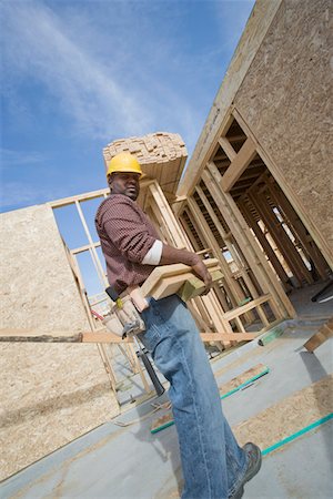 simsearch:693-06016727,k - Construction worker carrying wooden plank Stock Photo - Premium Royalty-Free, Code: 693-06016736