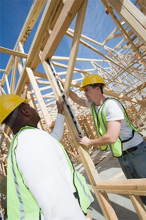 simsearch:693-06016727,k - Two construction workers measuring building framework Stock Photo - Premium Royalty-Free, Code: 693-06016739