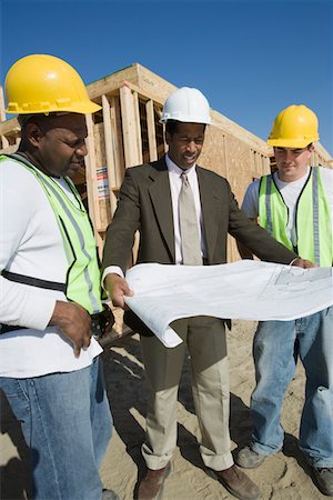 simsearch:693-06016727,k - Two construction workers and surveyor studying blueprint Stock Photo - Premium Royalty-Free, Code: 693-06016748