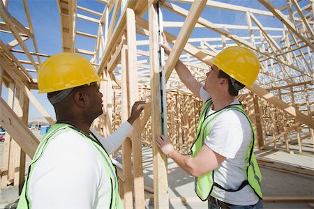simsearch:693-06016727,k - Two construction workers measuring building framework Stock Photo - Premium Royalty-Free, Code: 693-06016740