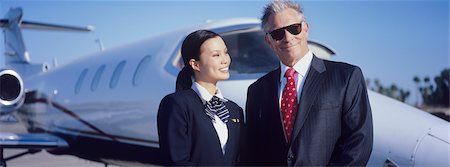 Businessman and Flight Crew Standing by Airplane Stock Photo - Premium Royalty-Free, Code: 693-06016944