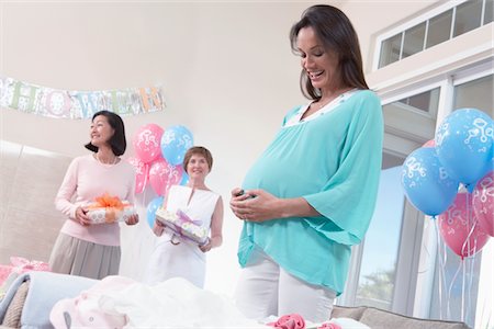 pregnant low angle - Pregnant Woman with Hands on Her Stomach at baby shower Stock Photo - Premium Royalty-Free, Code: 693-06017135