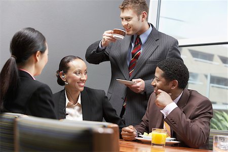 Businesspeople in eating and drinking in board room Stock Photo - Premium Royalty-Free, Code: 693-06017310