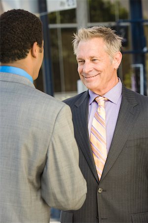 Two businessmen shaking hands, outdoors Stock Photo - Premium Royalty-Free, Code: 693-06017555