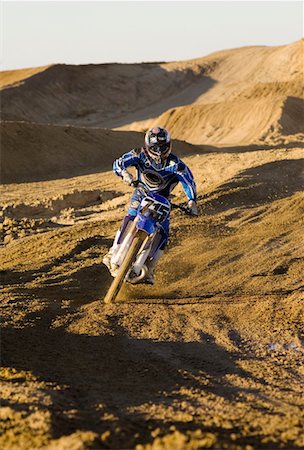 daredevil - Motocross racer riding on dirt track Stock Photo - Premium Royalty-Free, Code: 693-06018250
