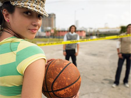 simsearch:693-03363602,k - Young Woman holding basketball in street, portrait Stock Photo - Premium Royalty-Free, Code: 693-06018428