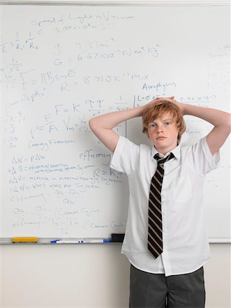 Elementary school student standing by whiteboard in math class, portrait Stock Photo - Premium Royalty-Free, Code: 693-06018531