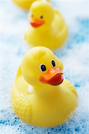 rubber duck - Row of rubber ducks in bubble bath, elevated view, close-up Stock Photo - Premium Royalty-Free, Code: 693-06018714