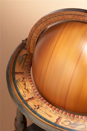 Spinning wooden globe in painted stand, cropped, in studio Stock Photo - Premium Royalty-Free, Code: 693-06018935