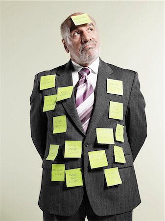 Businessman wearing sticky notes Stock Photo - Premium Royalty-Free, Code: 693-06018978