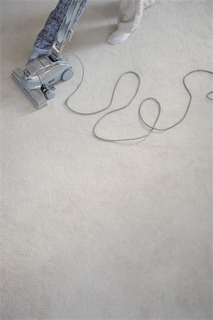 feet on carpet - Mature woman vacuuming carpet, low section Stock Photo - Premium Royalty-Free, Code: 693-06019124