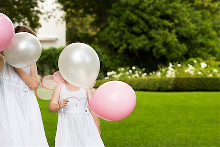 simsearch:693-03305634,k - Two young girls in garden, wearing white dresses, holding balloons Stock Photo - Premium Royalty-Free, Code: 693-06019198