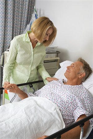 patient standing in hospital room - Woman visiting man in hospital Stock Photo - Premium Royalty-Free, Code: 693-06019283