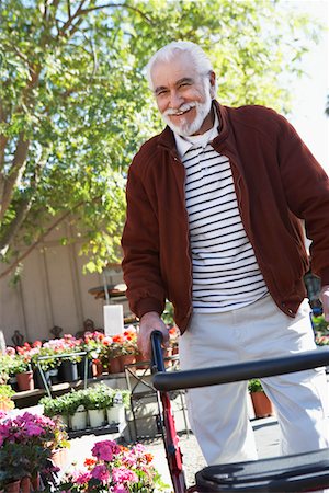 Elderly man with walking frame in garden center Stock Photo - Premium Royalty-Free, Code: 693-06019436