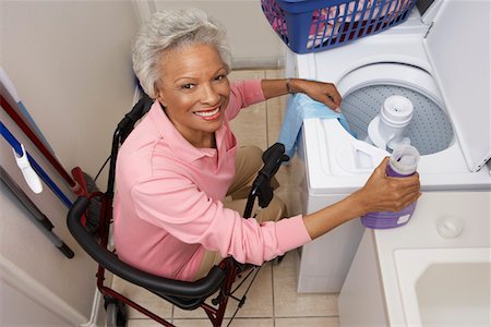 Woman doing laundry at home Stock Photo - Premium Royalty-Free, Code: 693-06019448