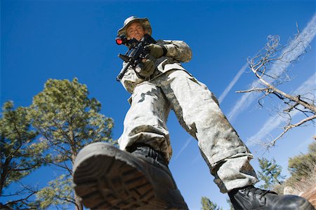 Low angle portrait of armed soldier Stock Photo - Premium Royalty-Free, Code: 693-06019817